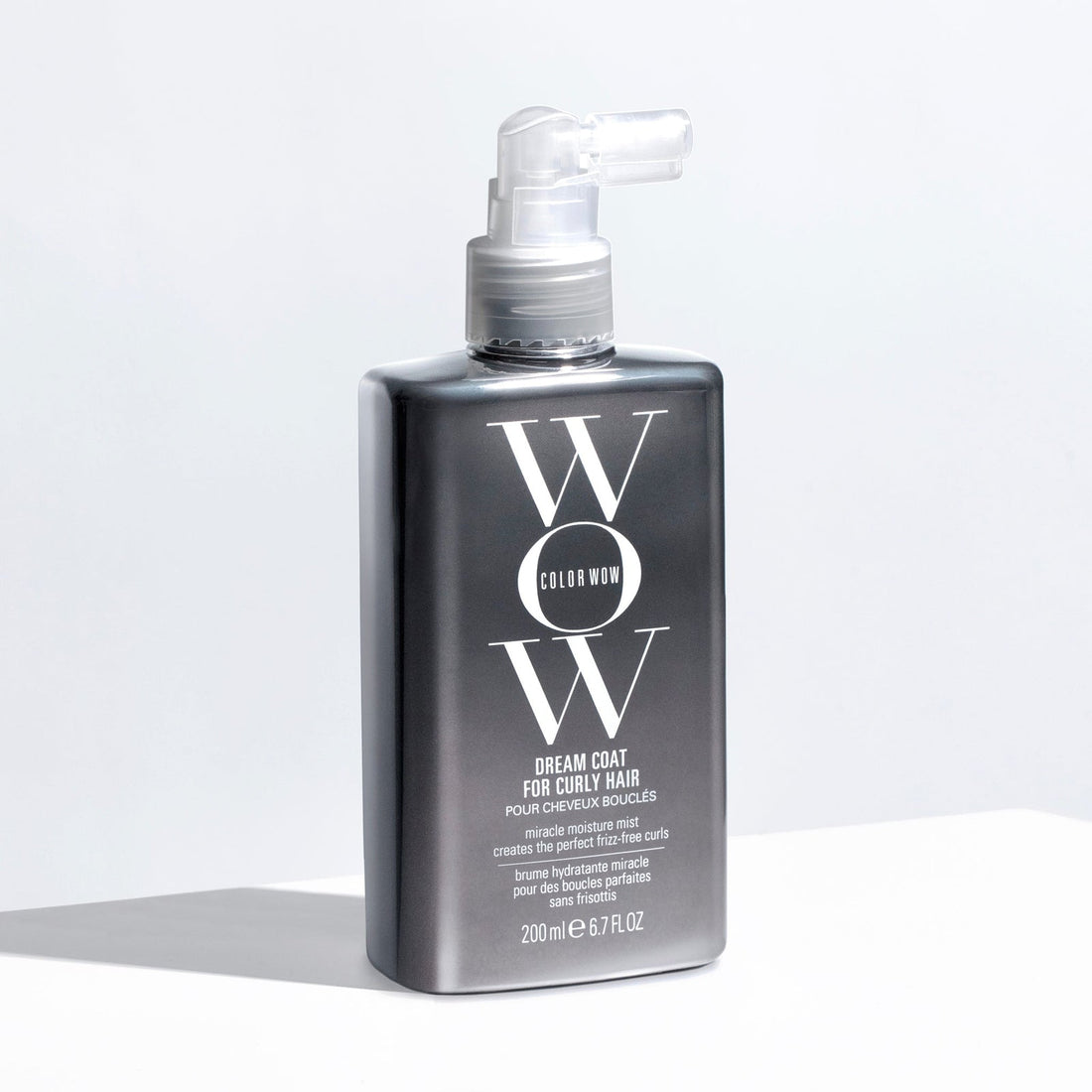 Color Wow Dream Coat for Curly Hair 200ml, hair styling spray bottle with curly hair, sleek packaging, and professional hair care branding